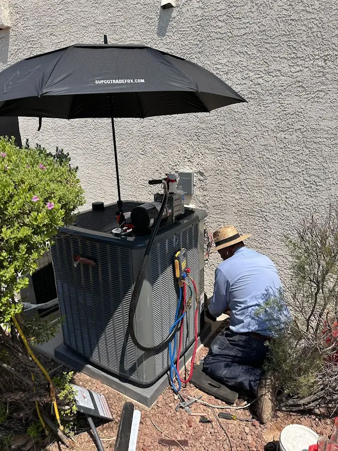 HVAC technician performing outdoor AC maintenance in Franklin Lakes
